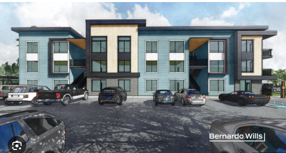 Photo of apartment complex and community center.